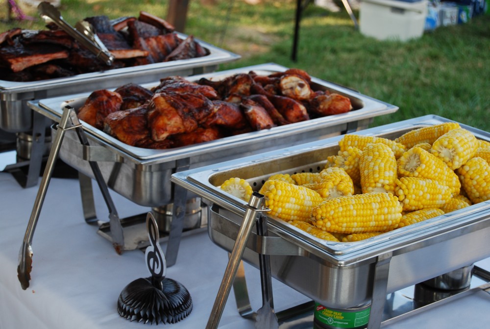 Flat-lay of people having barbeque party with meat and vegetables
