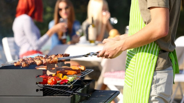 Flat-lay of people having barbeque party with meat and vegetables